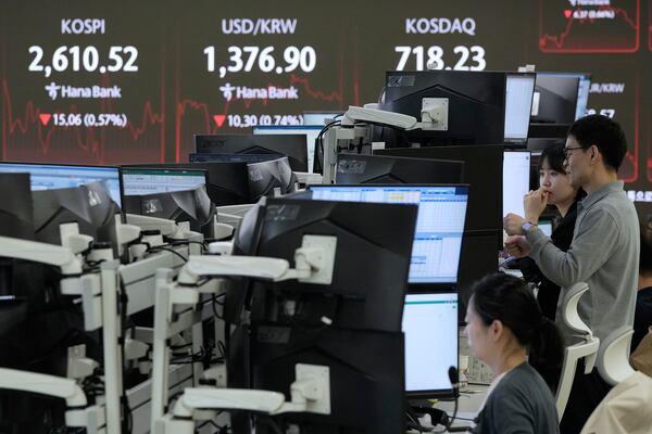 Currency traders watch monitors near a screen showing the Korea Composite Stock Price Index (KOSPI), top left, and the foreign exchange rate between U.S. dollar and South Korean won, top center, at the foreign exchange dealing room of the KEB Hana Bank headquarters in Seoul, South Korea, Thursday, May 22, 2025. (AP Photo/Ahn Young-joon)