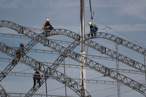 Workers begin the installation of a temporary shelter for possible deportees from the United States, in Ciudad Juarez, Mexico, Wednesday, Jan. 22, 2025. (AP Photo/Christian Chavez)