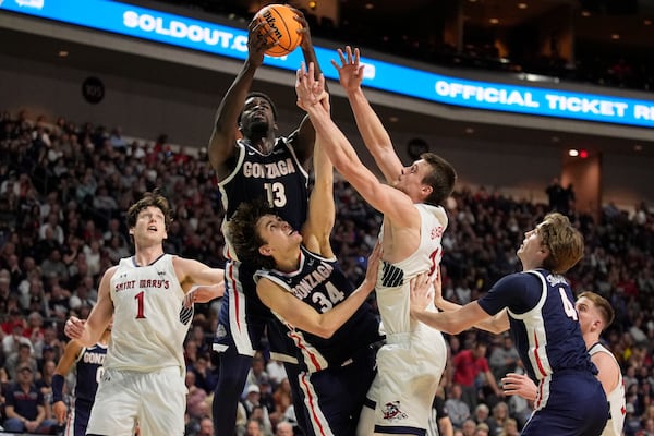 Gonzaga forward Graham Ike (13), Gonzaga forward Braden Huff (34) and Saint Mary's center Mitchell Saxen (11) battle for a rebound during the first half of an NCAA college basketball championship game in the West Coast Conference men's tournament Tuesday, March 11, 2025, in Las Vegas. (AP Photo/John Locher)