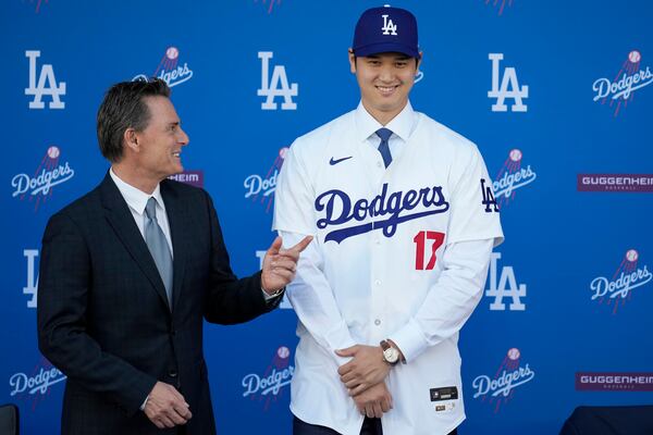 FILE - Los Angeles Dodgers' Shohei Ohtani, right, stands for photos next to agent Nez Balelo during a baseball news conference at Dodger Stadium Thursday, Dec. 14, 2023, in Los Angeles. (AP Photo/Ashley Landis, File)