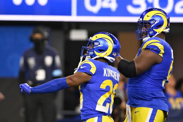 Los Angeles Rams safety Kamren Kinchens, left, celebrates after intercepting a pass during the second half of an NFL football game against the Arizona Cardinals, Saturday, Dec. 28, 2024, in Inglewood, Calif. (AP Photo/Alex Gallardo)