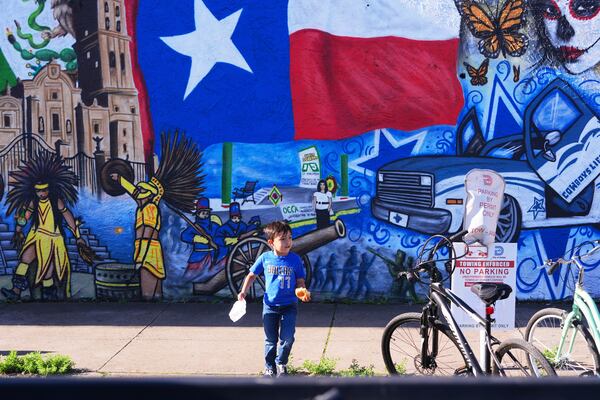 Luca Fernandez, 5, walks in front of a mural made by artist Jesus Alba to commemorate the 1862 battle of Puebla between the French and Mexican army during a Cinco De Mayo celebration in the Oak Cliff section of Dallas, May 3, 2025. (AP Photo/LM Otero)