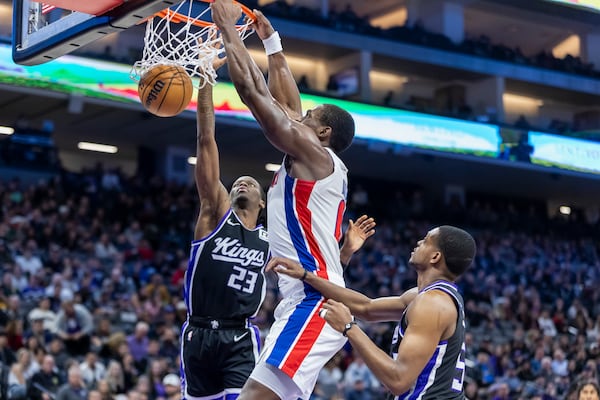 Detroit Pistons center Jalen Duren, center, dunks against Sacramento Kings guard Keon Ellis (23) during the first half of an NBA basketball game Thursday, Dec. 26, 2024, in Sacramento, Calif. (AP Photo/Sara Nevis)