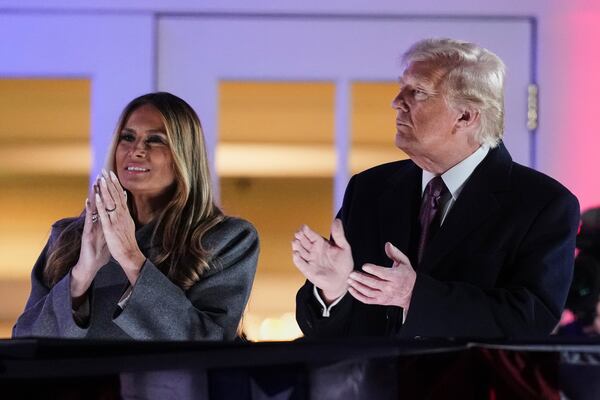 President-elect Donald Trump, right, and Melania Trump watch fireworks at Trump National Golf Club in Sterling, Va., Saturday, Jan. 18, 2025, ahead of the 60th Presidential Inauguration. (AP Photo/Matt Rourke)