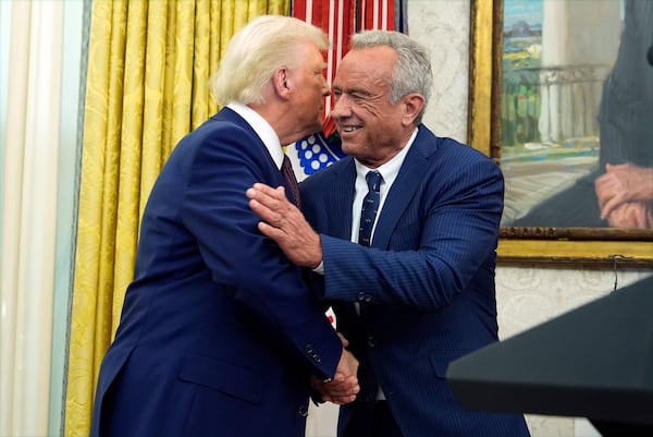 President Donald Trump congratulates Robert F. Kennedy Jr., after he was sworn in as Health and Human Services Secretary in the Oval Office at the White House, Thursday, Feb. 13, 2025, in Washington. (Photo/Alex Brandon)