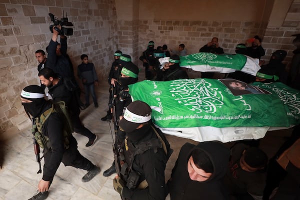 Masked militants from Hamas carry the body of Hamas leader Rawhi Mushtaha, during his funeral in Gaza City, Gaza Strip, Friday, Jan. 24, 2025. The Israeli military said Thursday that it killed a senior Hamas leader in an airstrike in the Gaza Strip around three months ago. (AP Photo/Abed Hajjar)