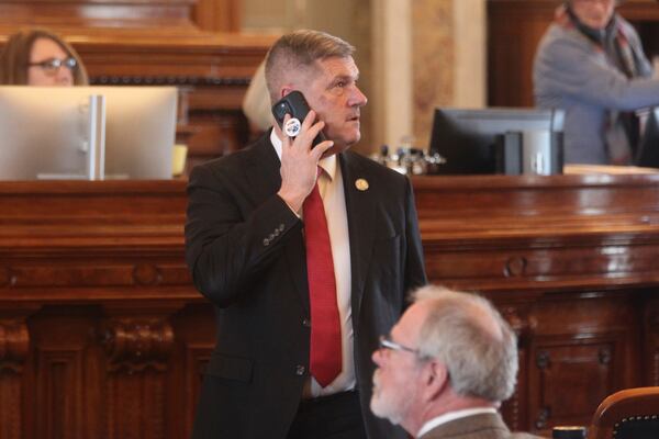 Kansas House Majority Leader Chris Croft, R-Overland Park, takes a phone call on the House floor ahead of a vote to override Democratic Gov. Laura Kelly's veto of a bill banning gender-affirming care for minors, Tuesday, Feb. 18, 2025, at the Statehouse in Topeka, Kansas. (AP Photo/John Hanna)