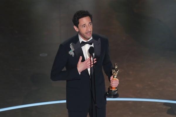 Adrien Brody accepts the award for best performance by an actor in a leading role for "The Brutalist" during the Oscars on Sunday, March 2, 2025, at the Dolby Theatre in Los Angeles.(AP Photo/Chris Pizzello)