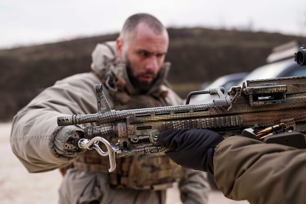 Andrii Rubliuk, a senior sergeant with a Ukrainian intelligence unit who lost both arms and a leg in combat, takes part in military training near Kyiv, Ukraine, on Feb. 14, 2025. (AP Photo/Evgeniy Maloletka)