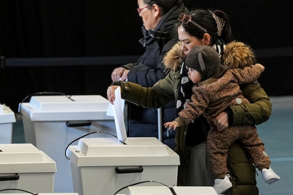 A woman casts her vote in parliamentary elections in Nuuk, Greenland, Tuesday, March 11, 2025. (AP Photo/Evgeniy Maloletka)