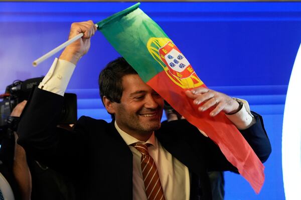 "The hard-right populist party Chega" leader Andre Ventura holds a Portugal's flag following Portugal's general election, in Lisbon, Monday, May 19, 2025. (AP Photo/Ana Brigida)
