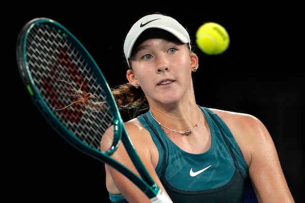 Mirra Andreeva of Russia plays a forehand return to Marie Bouzkova of the Czech Republic during their first round match at the Australian Open tennis championship in Melbourne, Australia, Sunday, Jan. 12, 2025. (AP Photo/Ng Han Guan)