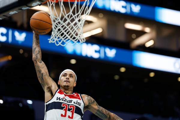 Washington Wizards forward Kyle Kuzma goes up for a dunk during the second half of an NBA basketball game against the Charlotte Hornets in Charlotte, N.C., Monday, Feb. 3, 2025. (AP Photo/Nell Redmond)