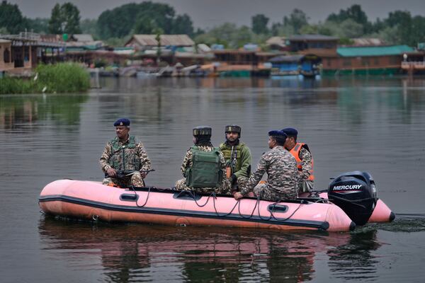 Paramilitary soldiers patrol on an inflatable boat on Dal Lake after loud explosions were heard in Srinagar, Indian controlled Kashmir, Saturday, May 10, 2025.(AP Photo/Mukhtar Khan)