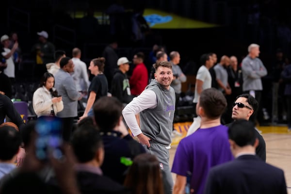 Los Angeles Lakers guard Luka Doncic, center, warms up before an NBA basketball game against the Dallas Mavericks, Tuesday, Feb. 25, 2025, in Los Angeles. (AP Photo/Mark J. Terrill)