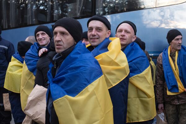 Ukrainian servicemen react after returning from captivity during a POWs exchange between Russia and Ukraine, in Chernyhiv region, Ukraine, Wednesday, March 19, 2025. (AP Photo/Efrem Lukatsky)