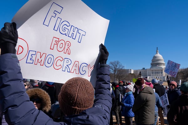 People protest as part of the “No Kings Day” protest on Presidents Day in Washington, in support of federal workers and against recent actions by President Donald Trump and Elon Musk, Monday, Feb. 17, 2025, by the Capitol in Washington. The protest was organized by the 50501 Movement, which stands for 50 Protests 50 States 1 Movement. (AP Photo/Jacquelyn Martin)