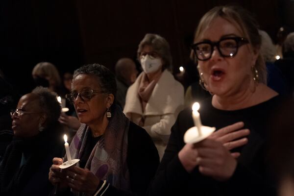 People sing during an interfaith vigil for sanctuary at the Cathedral Church of St. John the Divine, Wednesday, Feb. 12, 2025, in New York. (AP Photo/Julia Demaree Nikhinson)