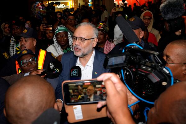 Expelled South Africa Ambassador Ebrahim Rasool speaks to journalist following his arrival, at Cape Town International Airport in Cape Town, South Africa, Sunday, March 23, 2025. (AP Photo/Nardus Engelbrecht)