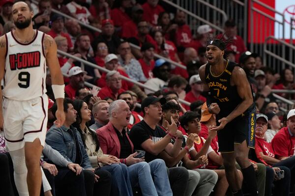 Golden State Warriors' Buddy Hield (7) reacts after making a three-pointer as Houston Rockets' Dillon Brooks (9) reacts during the first half of Game 7 of an NBA basketball first-round playoff series Sunday, May 4, 2025, in Houston. (AP Photo/Ashley Landis)