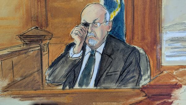 In this courtroom sketch, Salman Rushdie testifies on the witness stand, during the trial of Hadi Matar, Tuesday, Feb. 11, 2025 in Mayville, N.Y. showing how he was stabbed in the eye, when he was attacked in 2022. (Elizabeth Williams via AP)