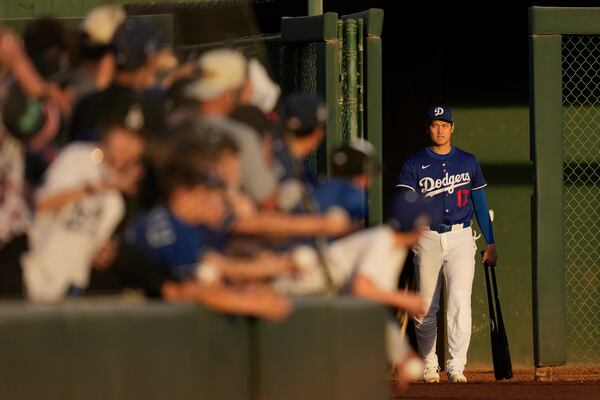 Los Angeles Dodgers designated hitter Shohei Ohtani enters the field before a spring training baseball game against the Los Angeles Angels, Friday, Feb. 28, 2025, in Phoenix. (AP Photo/Ashley Landis)