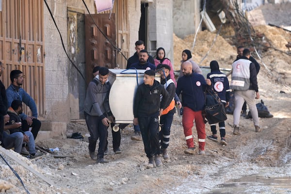 Residents of the West Bank urban refugee camp of Nur Shams evacuate their homes and carry their belongings as the Israeli military continues its operation in the area on Wednesday, Feb. 26, 2025. (AP Photo/Majdi Mohammed)