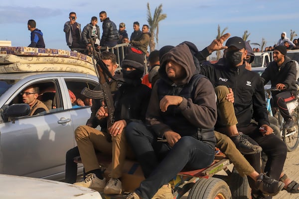 Displaced Palestinians, some armed, return to Rafah, as a ceasefire deal between Israel and Hamas went into effect, in Rafah, Gaza Strip, Sunday, Jan. 19, 2025. (AP Photo/Mariam Dagga)