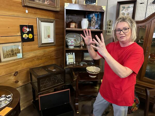 Michelle Hackworth discusses U.S. politics standing in her Paintsville, Ky., antiques store, Friday, May 16, 2025. (AP Photo/Bill Barrow)