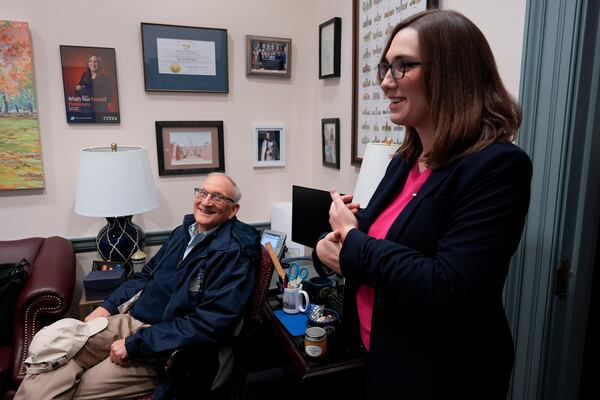 Dave McBride looks to his daughter, U.S.-Rep.-elect Sarah McBride, D-Del., on her last day as a Delaware state senator at the Delaware Legislative Hall in Dover, Del., Monday, Dec. 16, 2024. (AP Photo/Carolyn Kaster)