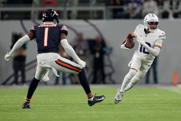 Minnesota Vikings wide receiver Justin Jefferson (18) runs from Chicago Bears cornerback Jaylon Johnson (1) during the first half of an NFL football game, Monday, Dec. 16, 2024, in Minneapolis. (AP Photo/Abbie Parr)