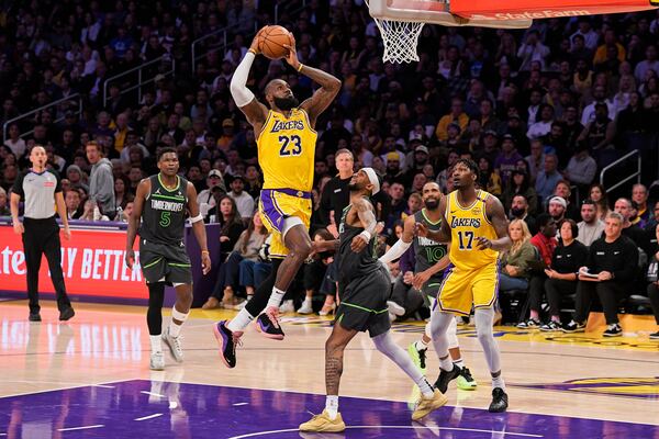 Los Angeles Lakers forward LeBron James (23) shoots as Minnesota Timberwolves guard Nickeil Alexander-Walker (9) defends during the first half in Game 5 of an NBA basketball first-round playoff series Wednesday, April 30, 2025, in Los Angeles. (AP Photo/Mark J. Terrill)