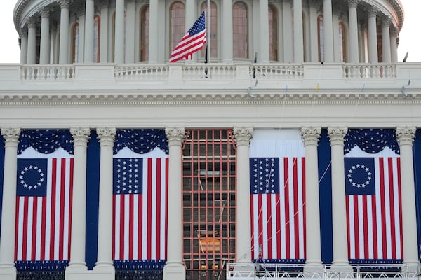 FILE - Flags hang in place on the West Front of the U.S. Capitol ahead of President-elect Donald Trump's upcoming inauguration, in Washington, Jan. 12, 2025. (AP Photo/Jon Elswick, File)