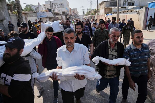 Palestinian carry the bodies of their relatives including children who were killed in an Israeli army airstrike in Deir al-Balah, Gaza, Wednesday, May 21, 2025. (AP Photo/Abdel Kareem Hana)