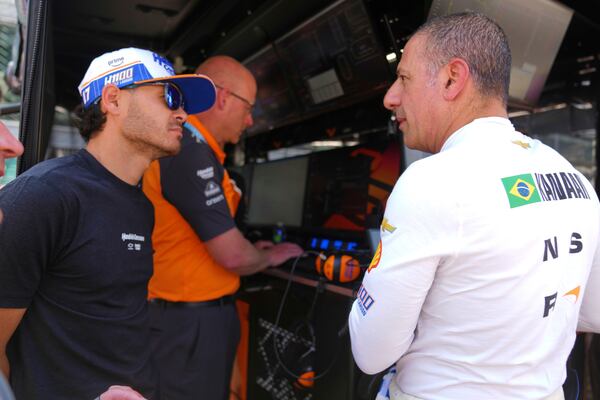Kyle Larson talks with Tony Kanaan, of Brazil, after Kanaan completed his refresher test during practice for the Indianapolis 500 auto race at Indianapolis Motor Speedway in Indianapolis, Thursday, May 15, 2025. (AP Photo/Michael Conroy)