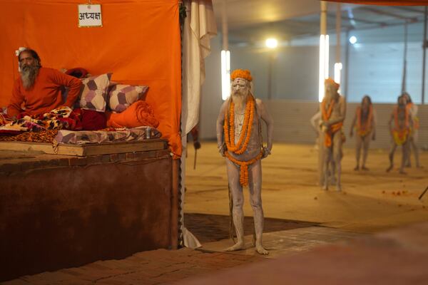 Nude Hindu holy men or a Naga Sadhus of Maharirwani Akhara prepare for a dip at Sangam, the confluence of the Rivers Ganges, Yamuna and mythical Saraswati on one of the most auspicious day Makar Sankranti, for the Mahakumbh festival in Prayagraj, Uttar Pradesh state, India, Tuesday, Jan. 14, 2025. (AP Photo/Rajesh Kumar Singh)