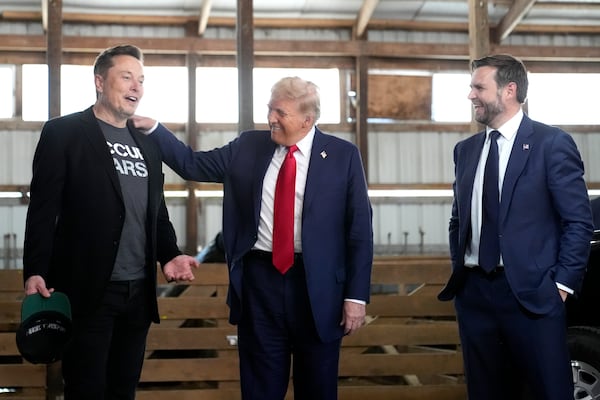 FILE - Tesla and SpaceX CEO Elon Musk, from left, Republican presidential nominee, former President Donald Trump and Republican vice presidential nominee, Sen. JD Vance, R-Ohio, attend a campaign event at the Butler Farm Show, in in Butler, Pa., Oct. 5, 2024. (AP Photo/Alex Brandon, File)