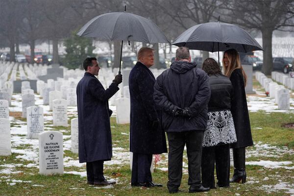 President-elect Donald Trump and Melina Trump talks with family members in Section 60 at Arlington National Cemetery, Sunday, Jan. 19, 2025, in Arlington, Va. (AP Photo/Evan Vucci)