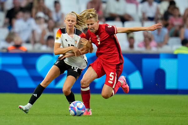 FILE - Germany's Laura Freigang fights for the ball with Canada's Quinn during a women's quarterfinal soccer match between Canada and Germany at the 2024 Summer Olympics, Saturday, Aug. 3, 2024, at Marseille Stadium in Marseille, France. (AP Photo/Julio Cortez, File)