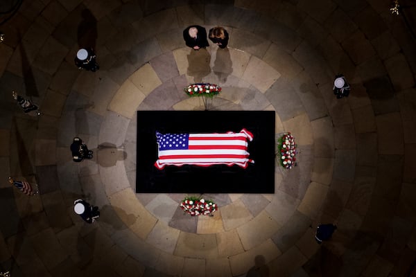 President-elect Donald Trump and Melania Trump pause at the flag-draped casket of former President Jimmy Carter as he lies in state in the rotunda of the U.S. Capitol in Washington, Wednesday, Jan. 8, 2025. (Andrew Harnik/Pool via AP)