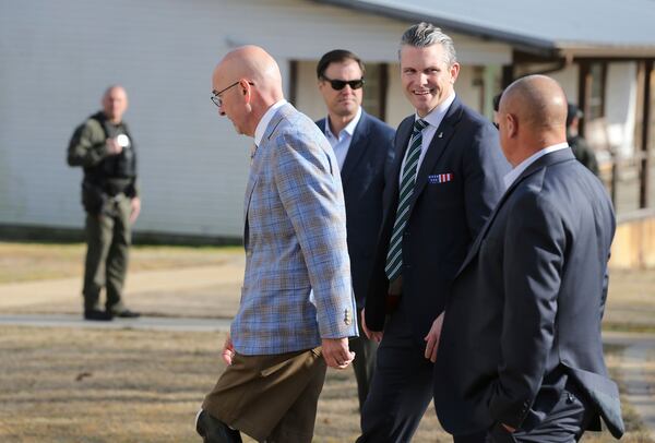 Secretary of Defense Pete Hegseth, center, walks with Scott Burns, left, as they enter "A Southern Salute to the Troops" fund raiser put on by the non-profit 7 Days for the Troops Thursday, March 20, 2025, in Tupelo Miss. (Thomas Wells /The Northeast Mississippi Daily Journal via AP)