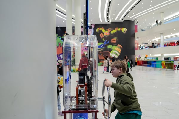 Brentley Joyce, 8, uses a penny press machine at the American Dream mall, Sunday, March 2, 2025, in East Rutherford, N.J. (AP Photo/Julia Demaree Nikhinson)