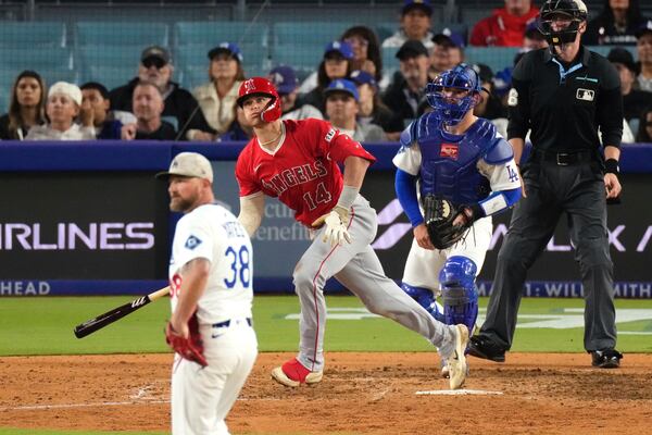 Los Angeles Angels' Logan O'Hoppe, second from left, heads to first for a three-run home run as Los Angeles Dodgers relief pitcher Kirby Yates, left, and catcher Dalton Rushing watches during the seventh inning of a baseball game Saturday, May 17, 2025, in Los Angeles. (AP Photo/Mark J. Terrill)