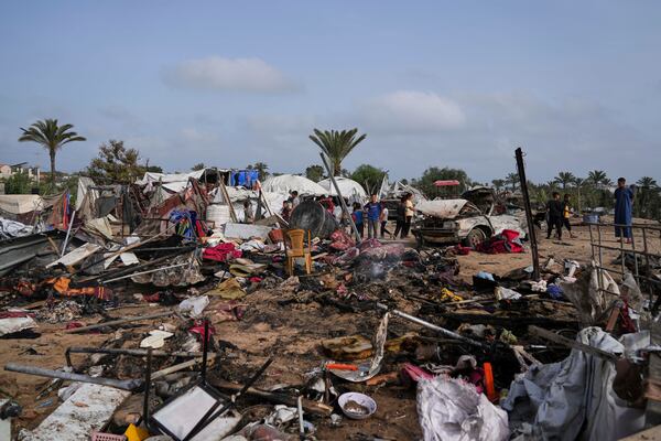 Palestinians inspect the site destroyed by Israeli airstrikes in Khan Younis, Gaza Strip, Sunday, May 18, 2025. (AP Photo/Abdel Kareem Hana)