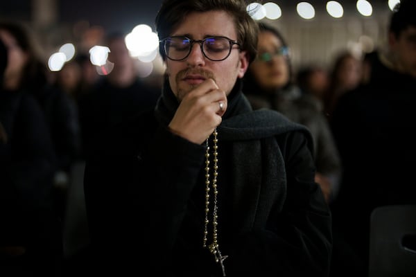 A Catholic man attends a nightly rosary prayer service for the health of Pope Francis in St. Peter's Square at the Vatican, Wednesday, Feb. 26, 2025. (AP Photo/Bernat Armangue)