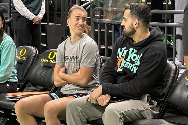 New York Liberty guard Sabrina Ionescu, left, talks with assistant coach Zach O'Brien, right, before a preseason WNBA basketball game against the Toyota Antelopes, of Japan, in Eugene, Oregon, Monday, May 12, 2025. (AP Photo/Anne M. Peterson).