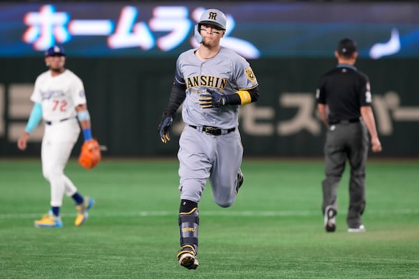 Hanshin Tigers' Teruaki Sato runs the bases after hitting a three-run home run against the Los Angeles Dodgers during the fourth inning in an MLB Japan Series exhibition baseball game, Sunday, March 16, 2025, in Tokyo. (AP Photo/Eugene Hoshiko)