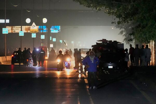 Pakistani police officers remove vehicles and people from the main entry of Nur Khan airbase following an Indian missile strike in Rawalpindi, Pakistan, Saturday, May 10, 2025. (AP Photo/Anjum Naveed)