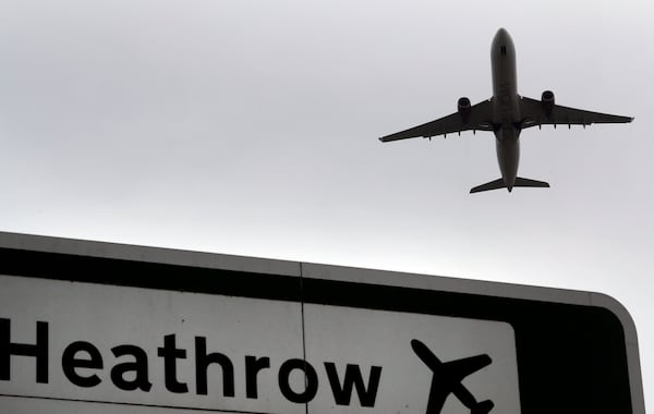 FILE - A plane takes off over a road sign near Heathrow Airport in London, June 5, 2018. (AP Photo/Kirsty Wigglesworth, File)