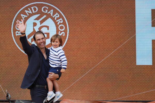 Rafa Nadal holds his son Rafael Junior during a farewell ceremony at center court Philippe-Chatrier, at the Roland-Garros stadium, in Paris, Sunday May 25, 2025. (AP Photo/Thibault Camus)